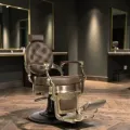 Clovis gold barber chair - luxury barber chair - golden barber chair - vintage barbershop chair - high-end barber furniture - professional hairdressing chair - hydraulic barber chair - upholstered barber chair - robust barber chair - golden design barber chair - luxury retro barber chair - premium barbershop equipment - comfortable barber chair - adjustable barber chair - golden aluminum barber chair