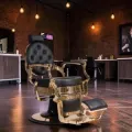 CLOVIS Barber Chair (2) Clovis gold barber chair - luxury barber chair - golden barber chair - vintage barbershop chair - high-end barber furniture - professional hairdressing chair - hydraulic barber chair - upholstered barber chair - robust barber chair - golden design barber chair - luxury retro barber chair - premium barbershop equipment - comfortable barber chair - adjustable barber chair - golden aluminum barber chair