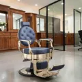Clovis gold barber chair - luxury barber chair - golden barber chair - vintage barbershop chair - high-end barber furniture - professional hairdressing chair - hydraulic barber chair - upholstered barber chair - robust barber chair - golden design barber chair - luxury retro barber chair - premium barbershop equipment - comfortable barber chair - adjustable barber chair - golden aluminum barber chair